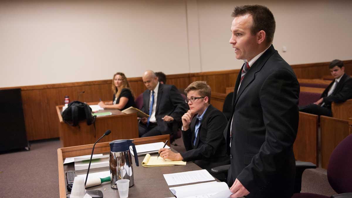 College of Law student in a courtroom during a mock trial.