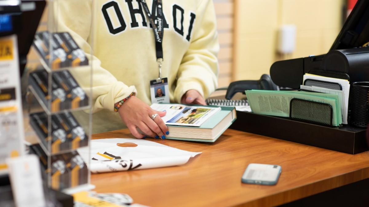 Student working the register at the VandalStore